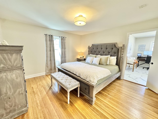 bedroom featuring light wood-type flooring and baseboards