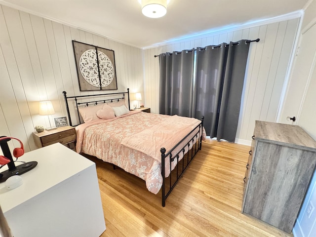 bedroom featuring light wood-style floors and ornamental molding