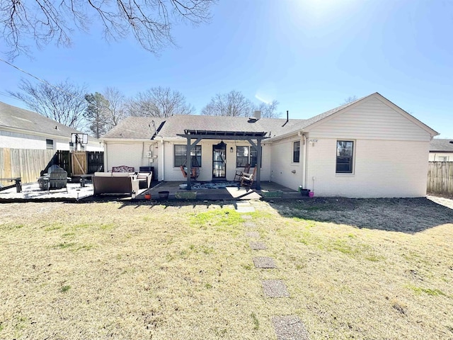 back of house with a yard, a fenced backyard, a pergola, a patio area, and brick siding