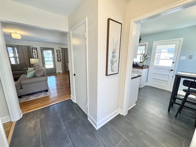 hallway with baseboards and dark wood-style flooring