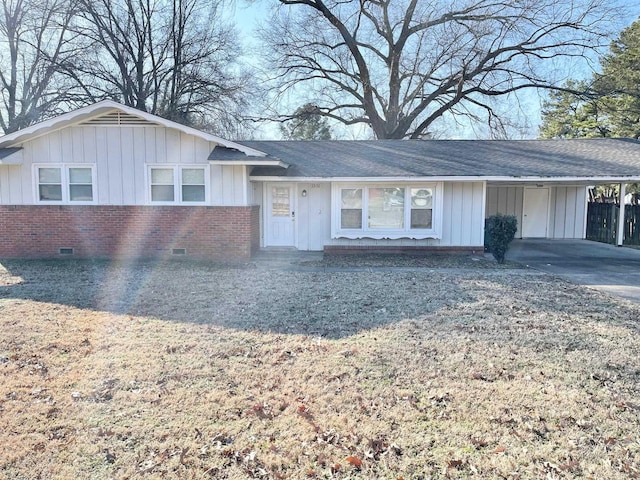 ranch-style house featuring a carport, board and batten siding, concrete driveway, crawl space, and brick siding