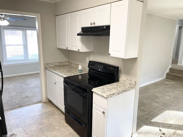 kitchen with under cabinet range hood, light colored carpet, light countertops, white cabinetry, and black / electric stove