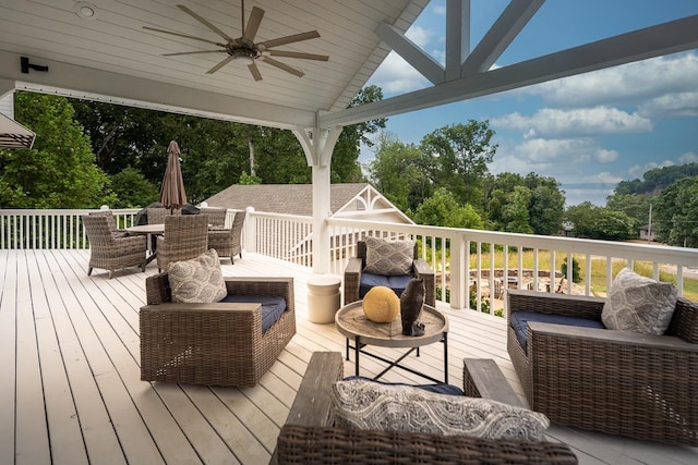 wooden deck featuring ceiling fan, an outdoor living space, and outdoor dining space