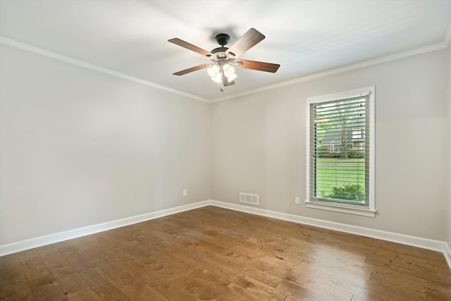 empty room featuring ornamental molding, a ceiling fan, baseboards, and wood finished floors