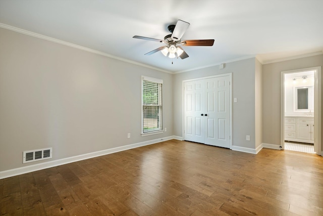 unfurnished bedroom featuring visible vents, baseboards, and hardwood / wood-style floors