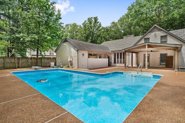 view of pool featuring a patio, a fenced backyard, a fenced in pool, and ceiling fan