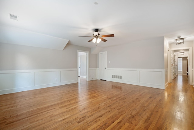 unfurnished living room with visible vents, light wood-style floors, and a ceiling fan