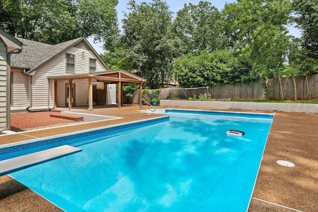 view of pool with a fenced in pool, a fenced backyard, and a diving board