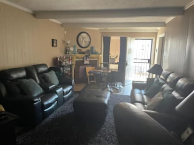 living area featuring beam ceiling and crown molding