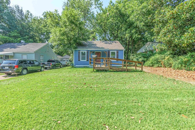 view of front of home featuring a wooden deck and a front yard