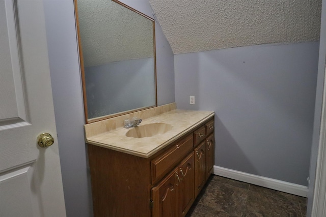 134 Willow Creek Dr, Ripley, TN 38063 - bathroom featuring vanity, a textured ceiling, lofted ceiling, and baseboards