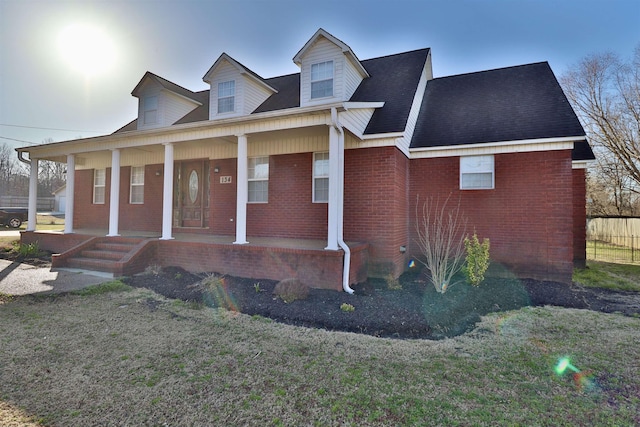 134 Willow Creek Dr, Ripley, TN 38063 - cape cod home with brick siding, covered porch, and a front yard