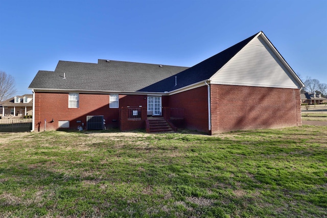 134 Willow Creek Dr, Ripley, TN 38063 - rear view of property with central air condition unit, fence, a lawn, and brick siding