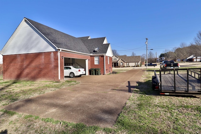 134 Willow Creek Dr, Ripley, TN 38063 - view of side of property with driveway, roof with shingles, a garage, a lawn, and brick siding