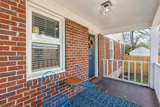 view of patio with covered porch and fence