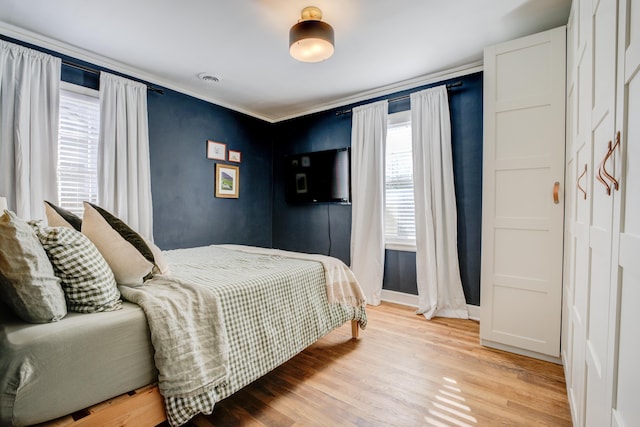 bedroom with visible vents, baseboards, and light wood-style flooring