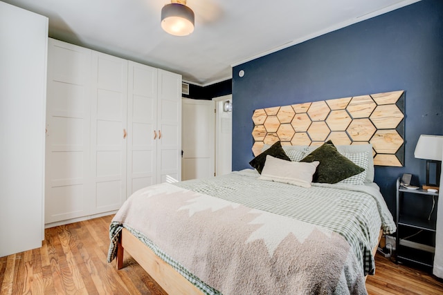 bedroom with a closet and wood finished floors