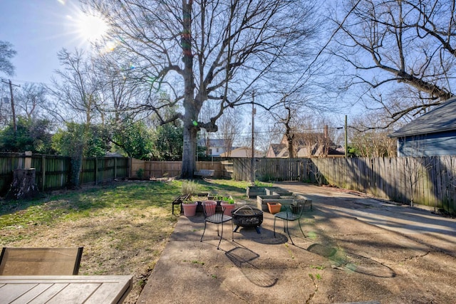 view of yard with a patio, a fire pit, and a fenced backyard