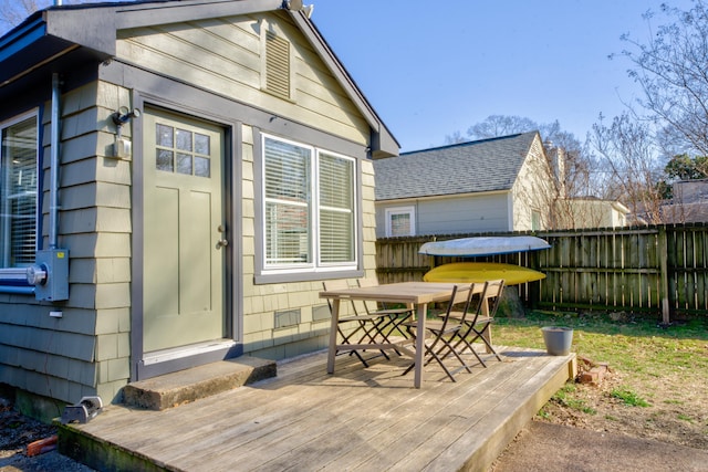 exterior space with outdoor dining area, entry steps, and fence