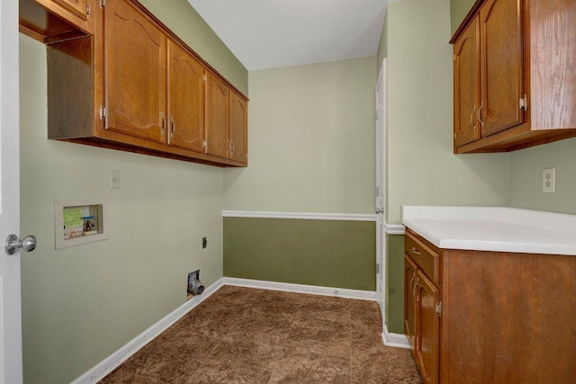 laundry room featuring baseboards, cabinet space, and washer hookup