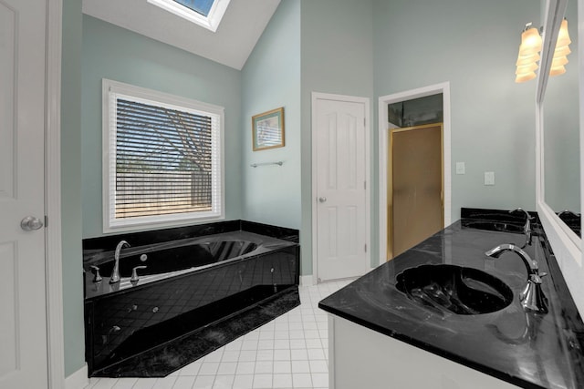 bathroom featuring tile patterned flooring, vaulted ceiling with skylight, double vanity, and a sink