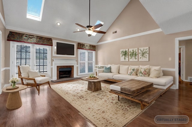 living area featuring dark wood finished floors, a skylight, visible vents, and high vaulted ceiling