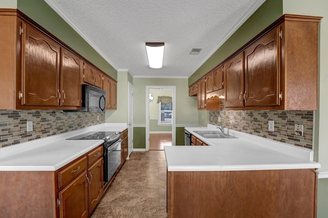 kitchen with visible vents, ornamental molding, a peninsula, black appliances, and a sink