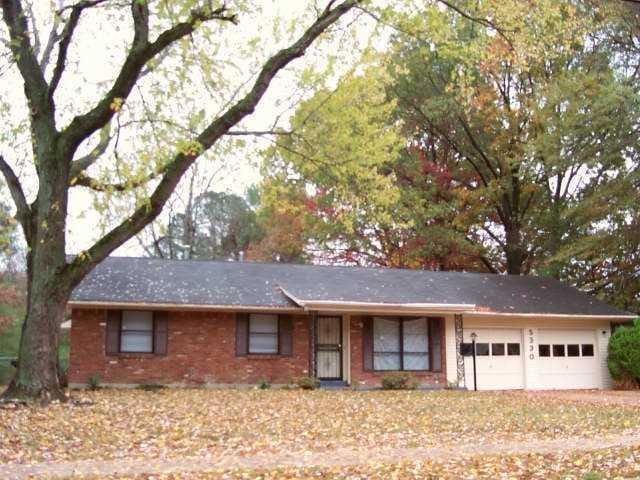 ranch-style home with brick siding and a garage