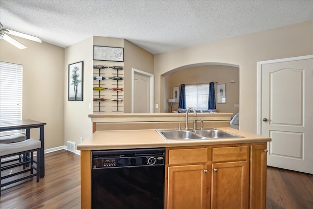 kitchen featuring visible vents, dishwasher, light countertops, a ceiling fan, and a sink