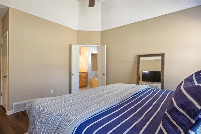 bedroom featuring visible vents, connected bathroom, ceiling fan, wood finished floors, and a textured ceiling