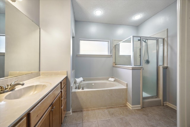 full bath with tile patterned floors, a textured ceiling, a stall shower, and a bath