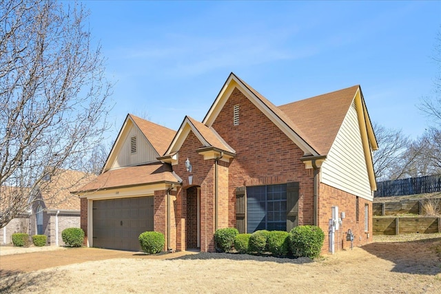 traditional-style home with an attached garage, brick siding, and driveway