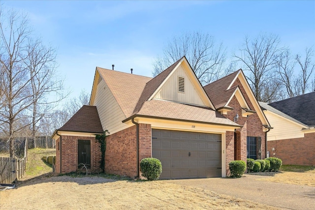 view of front of property featuring driveway, brick siding, board and batten siding, and an attached garage