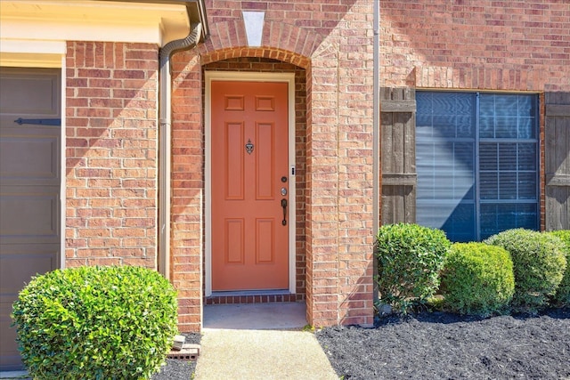 doorway to property with brick siding