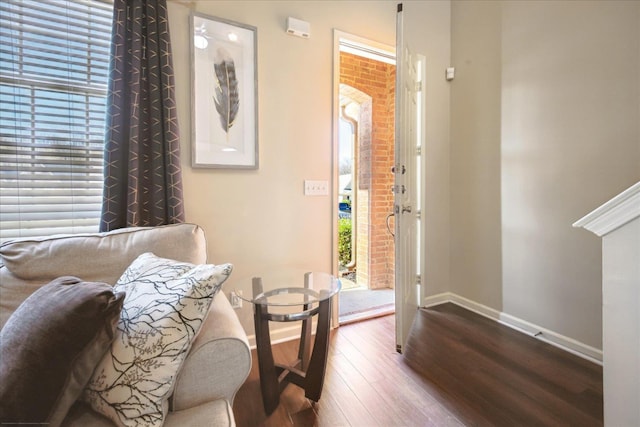 interior space with baseboards and wood finished floors