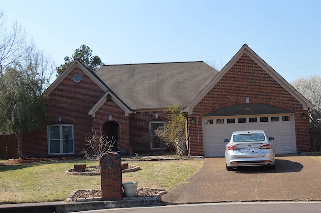 view of front facade with a garage, a front lawn, concrete driveway, and brick siding