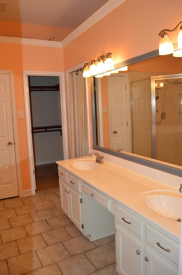 bathroom with a sink, a closet, ornamental molding, and double vanity