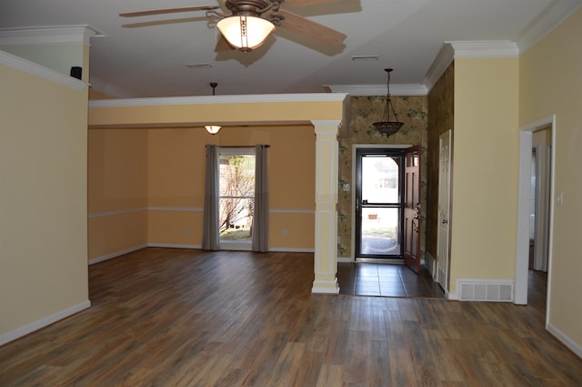 entrance foyer with visible vents, ornamental molding, and decorative columns