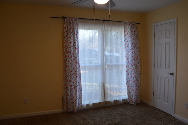 empty room with baseboards, a ceiling fan, and carpet floors