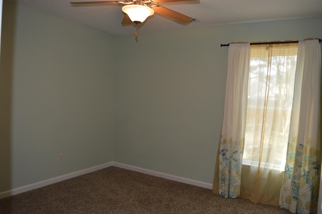 empty room with a ceiling fan, baseboards, and carpet floors