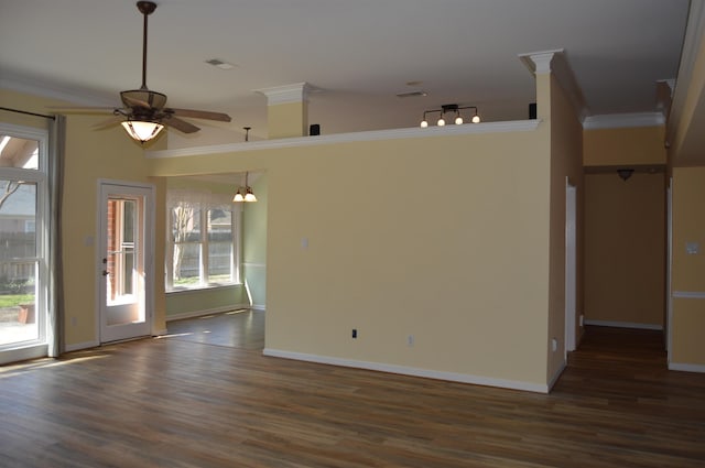 unfurnished room featuring baseboards, wood finished floors, and crown molding