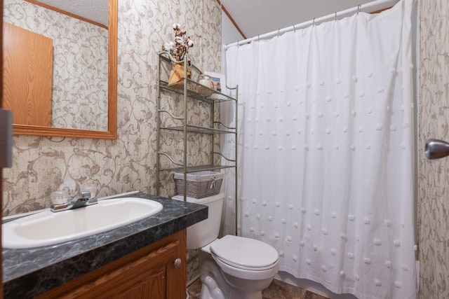 bathroom featuring a textured ceiling, toilet, vanity, and wallpapered walls