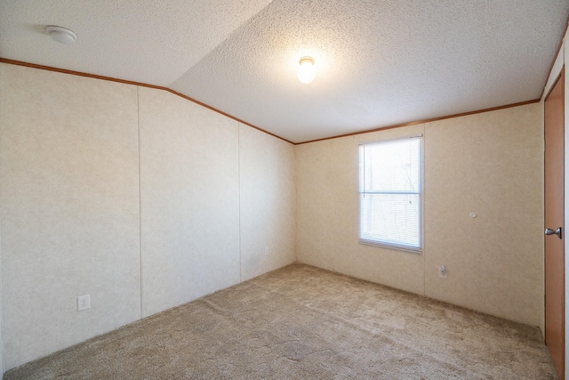 carpeted spare room featuring crown molding, lofted ceiling, and a textured ceiling