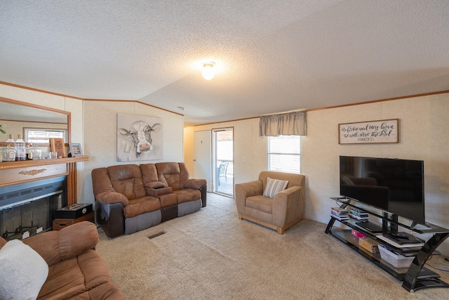 living area featuring carpet, a fireplace, and crown molding