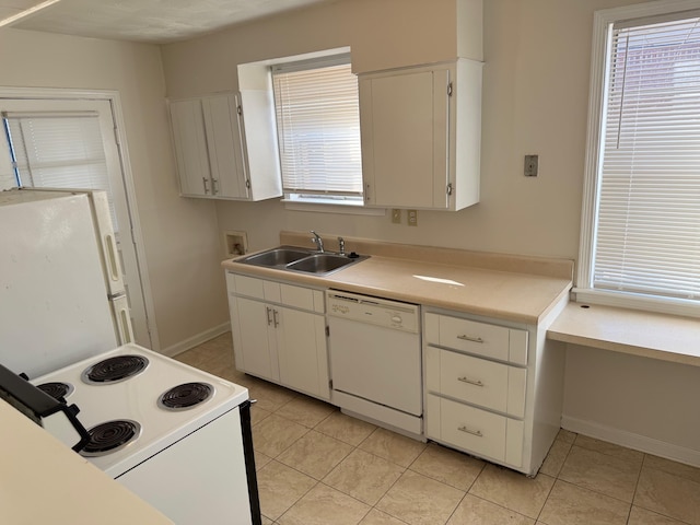 kitchen with white cabinets, white appliances, light countertops, and a sink