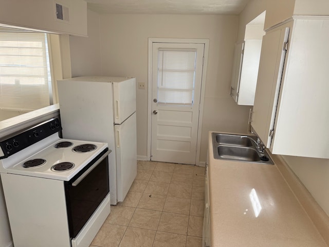 kitchen featuring white range with electric stovetop, white cabinets, light countertops, and a sink