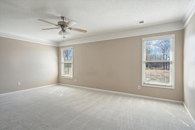 unfurnished room featuring visible vents, light colored carpet, crown molding, and a ceiling fan