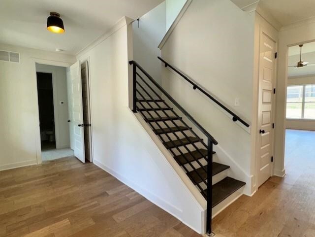 5876 Milton Wilson Blvd, Arlington, TN 38002 - stairway featuring baseboards, visible vents, ornamental molding, and wood finished floors