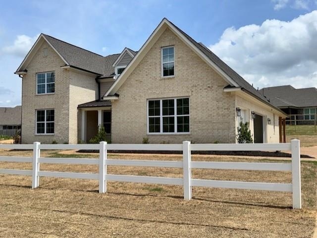 5876 Milton Wilson Blvd, Arlington, TN 38002 - traditional-style home with brick siding, fence, and a garage