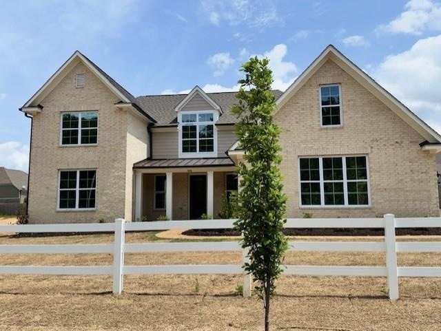 5876 Milton Wilson Blvd, Arlington, TN 38002 - view of front of property featuring a standing seam roof, fence private yard, metal roof, and brick siding